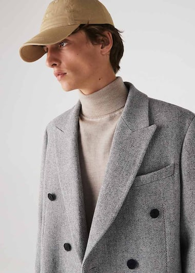 Collar detail of coat in grey herringbone wool