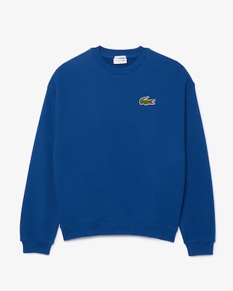 Sudadera unisex de tejido polar con detalle de insignia y corte holgado