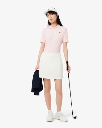 Polo de golf elástico con protección UV y corte entallado para mujer